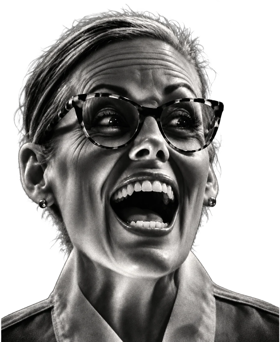 Gov. Katie Hobbs, laughing with her mouth wide open.